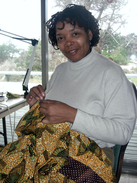 Sandra sews her dress.